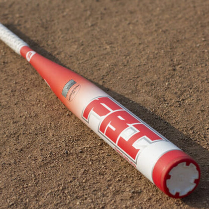 Chris Walker's new Senior Softball bat laying in the dirt of a baseball field...the FBI Hall of Fame bat from Headbanger Sports