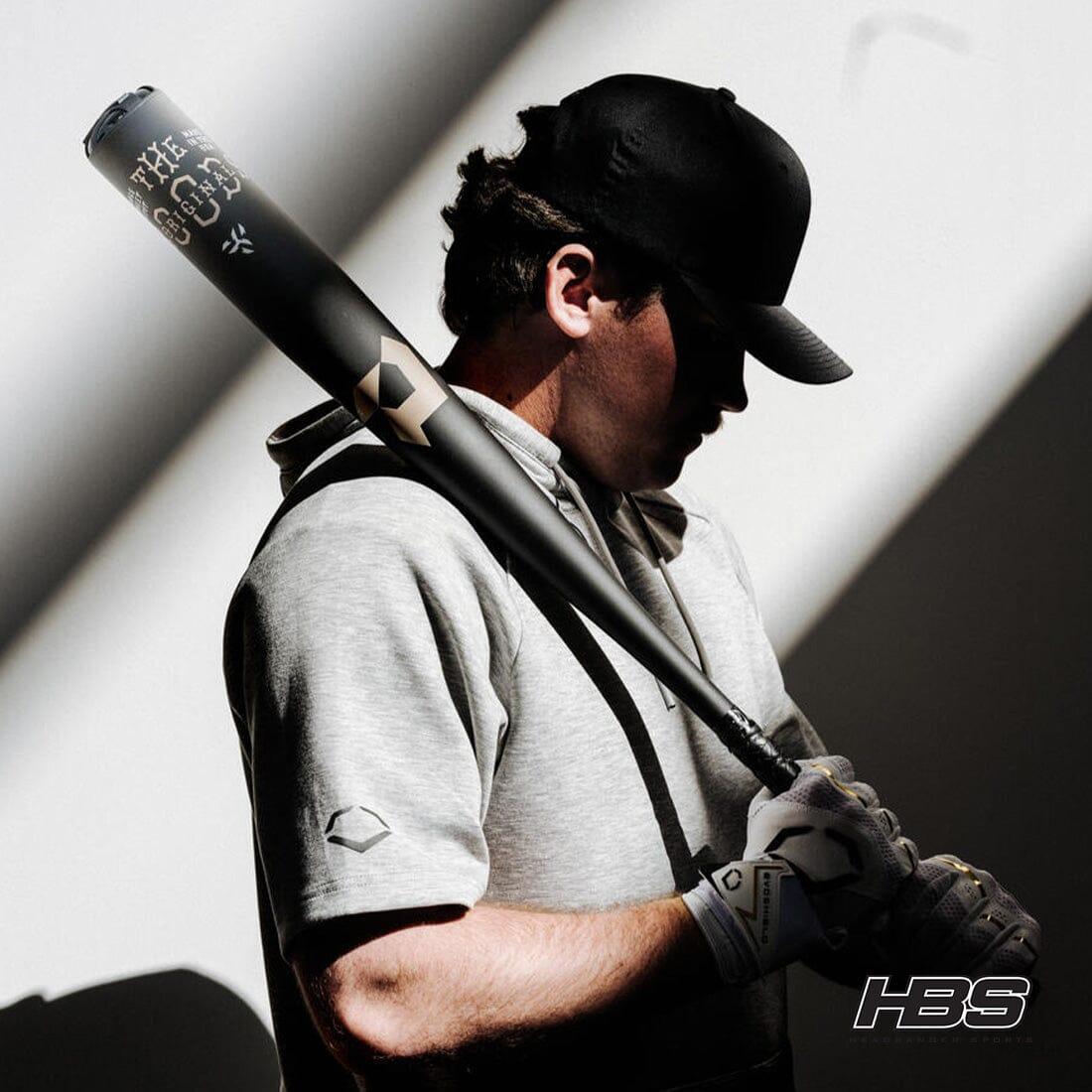 Baseball Player Holding the Goods One Piece BBCOR Baseball Bat in the Shadows