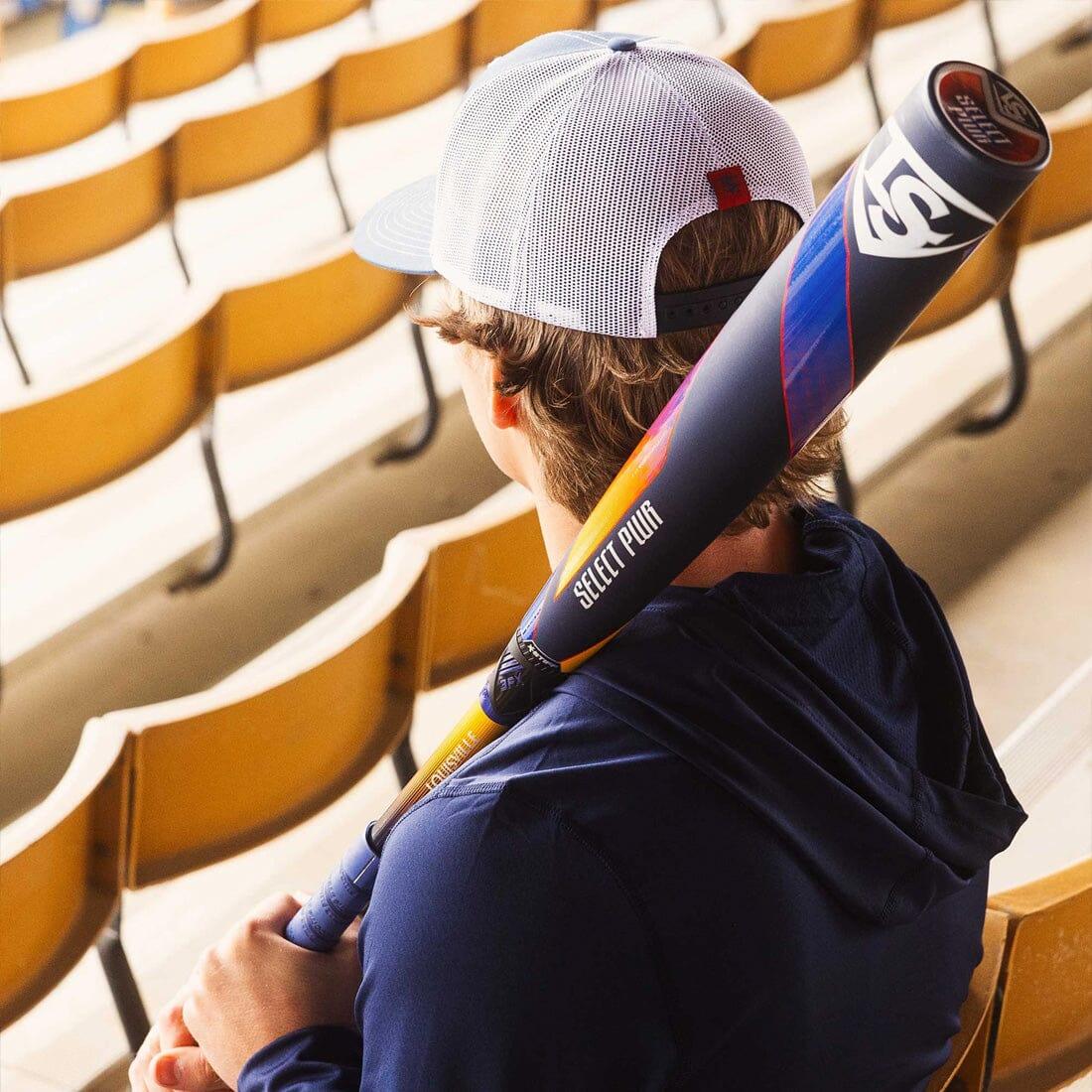 A Baseball Player Sitting in the Stands holding a 2025 Louisville Select PWR (-3) BBCOR Baseball Bat at Headbanger Sports