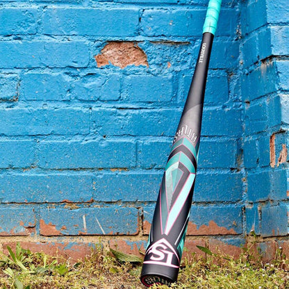 A 2025 Louisville Slugger ATLAS (-3) BBCOR Baseball Bat from Headbanger Sports leaning up against a blue concrete brick wall