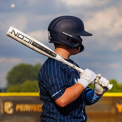 A baseball player swinging a -5 Rawlings Icon USSSA Baseball Bat from Headbanger Sports