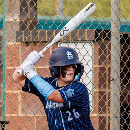 A youth baseball player holding the new Rawlings 2025 Icon from Headbanger Sports while swinging in the batting cage